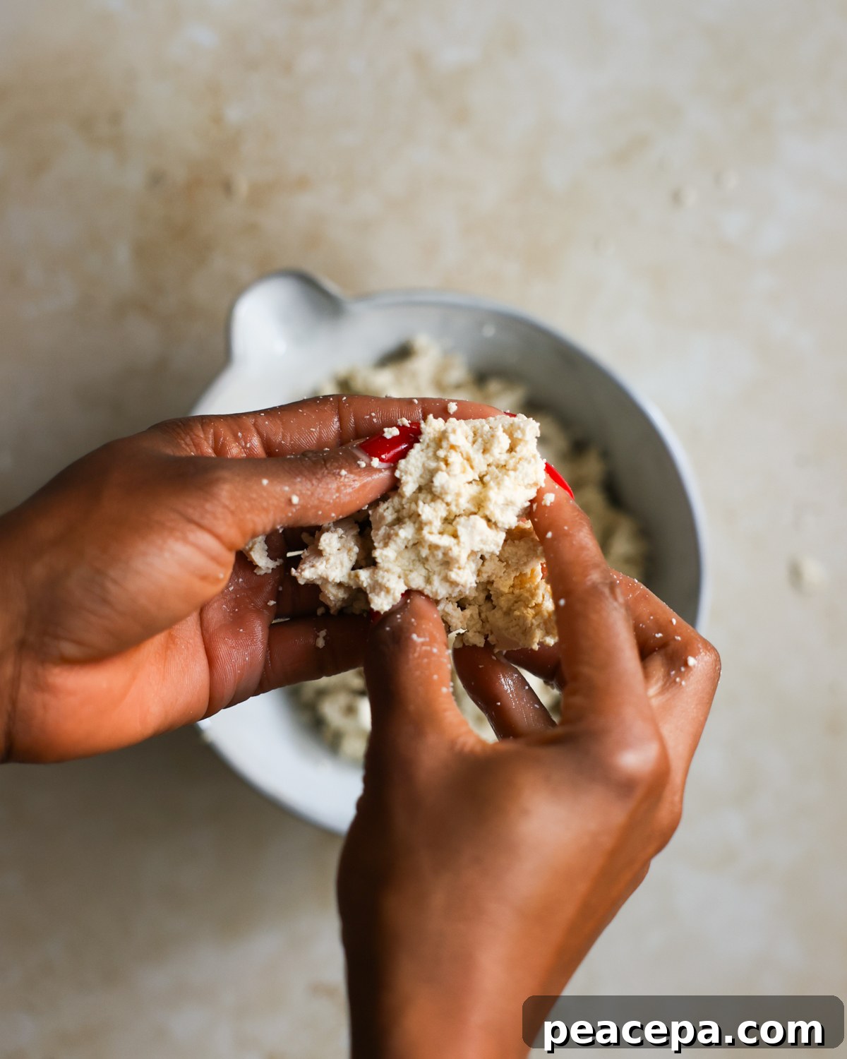overhead crumbling tofu in hands