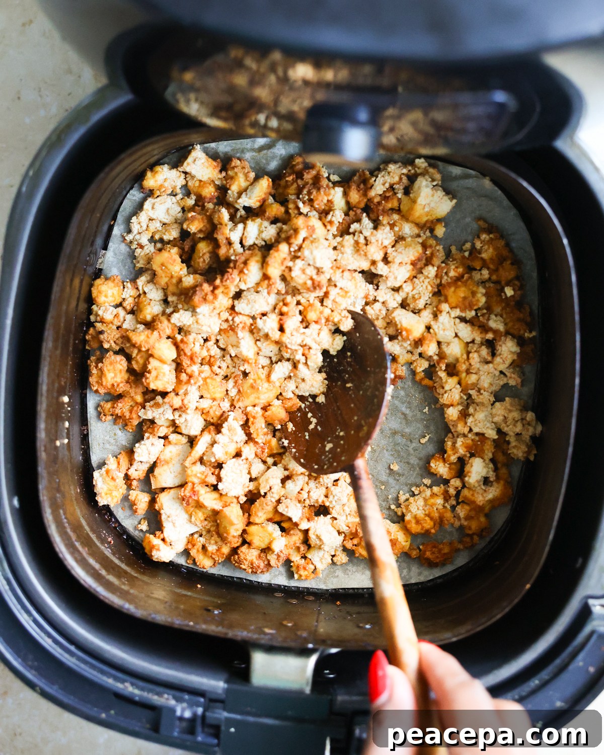 stirring tofu in air fryer