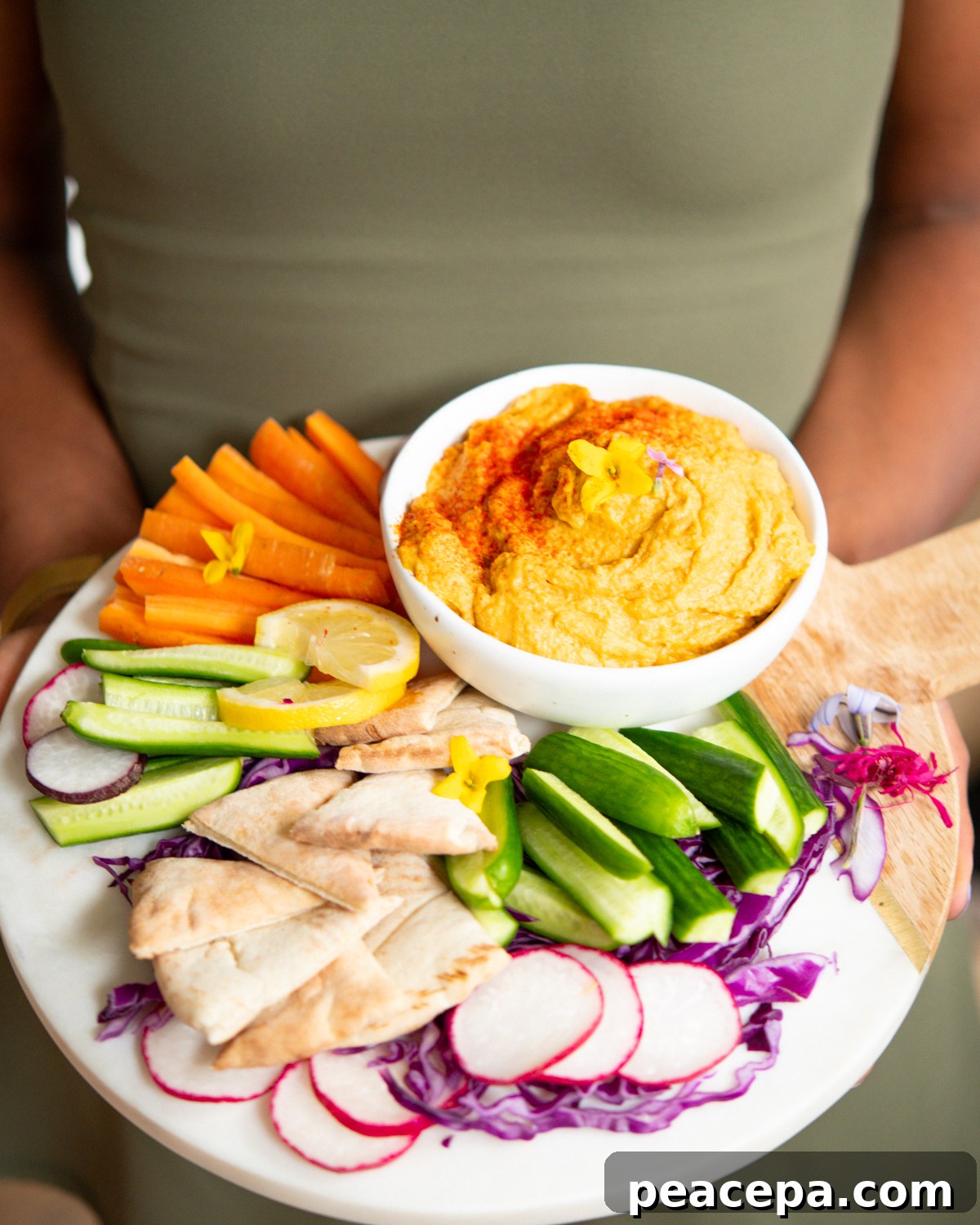 holding hummus platter