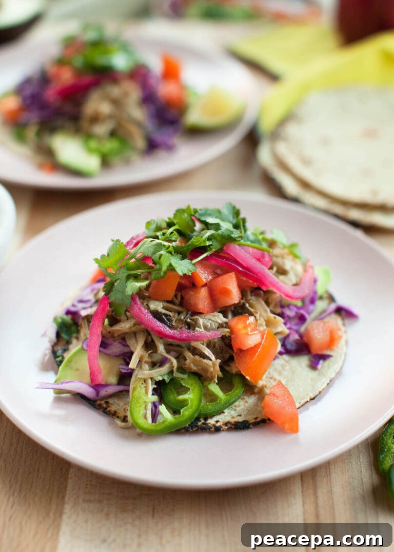 mushroom carnitas tacos on a light pink plate