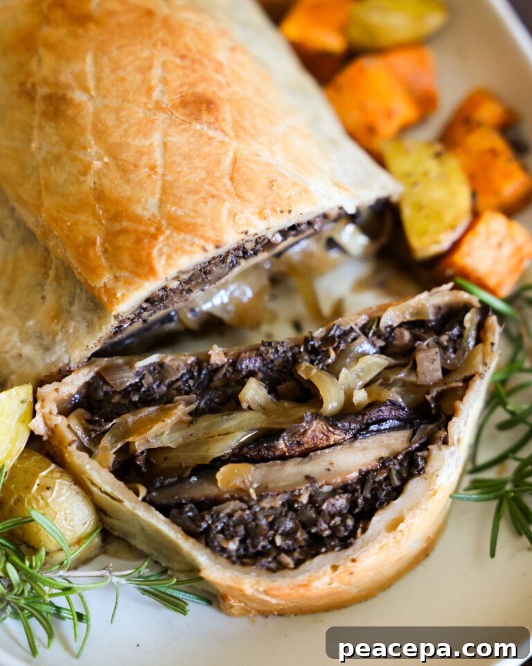 A close up shot of the baked mushroom Wellington with a slice taken out of it.