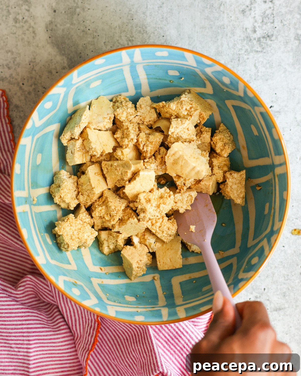stirring tofu in bowl