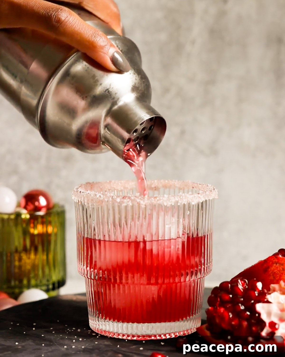 pouring pomegranate margarita