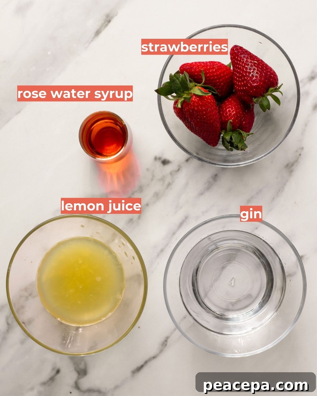 An overhead shot of the ingredients needed to make strawberry rose bramble cocktail.