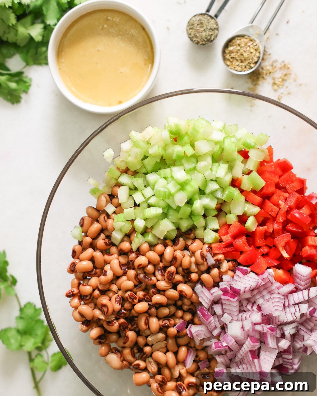 black eyed pea salad ingredients on a white countertop