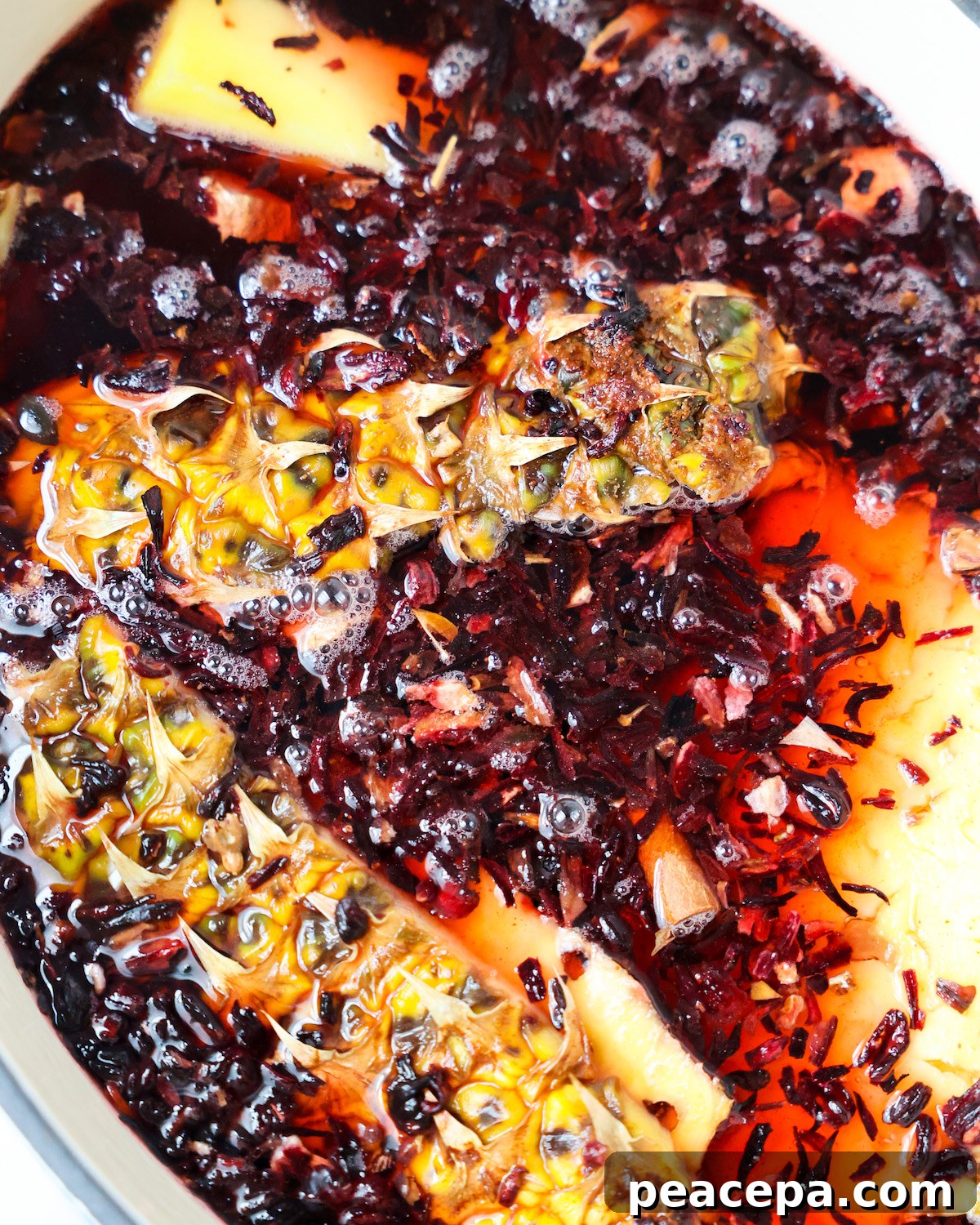 Closeup of pineapple skins and hibiscus in pot