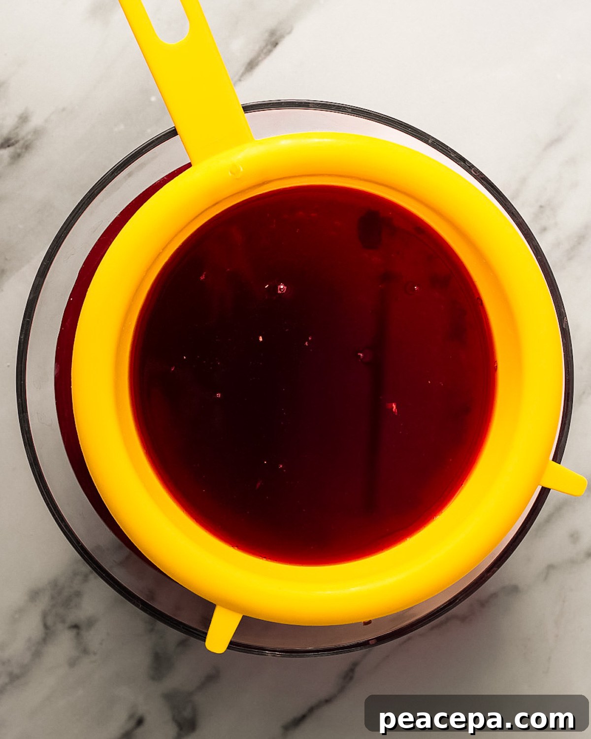 strainer removing solids from tea