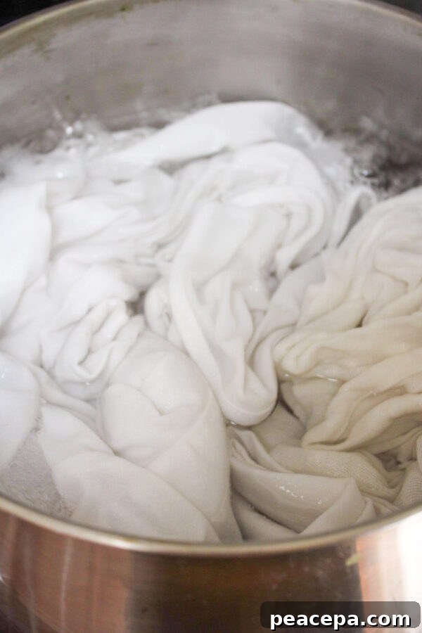 White fabric in a pot with alum mordant.