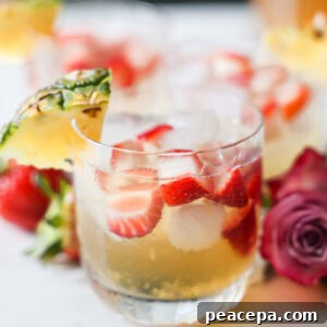 A close up shot of a small cup of pineapple summer sangria on the counter.