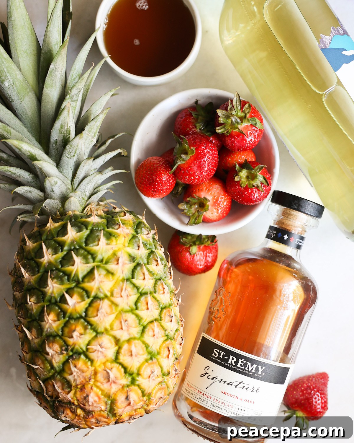 An overhead shot of the ingredients for pineapple summer sangria on the counter.