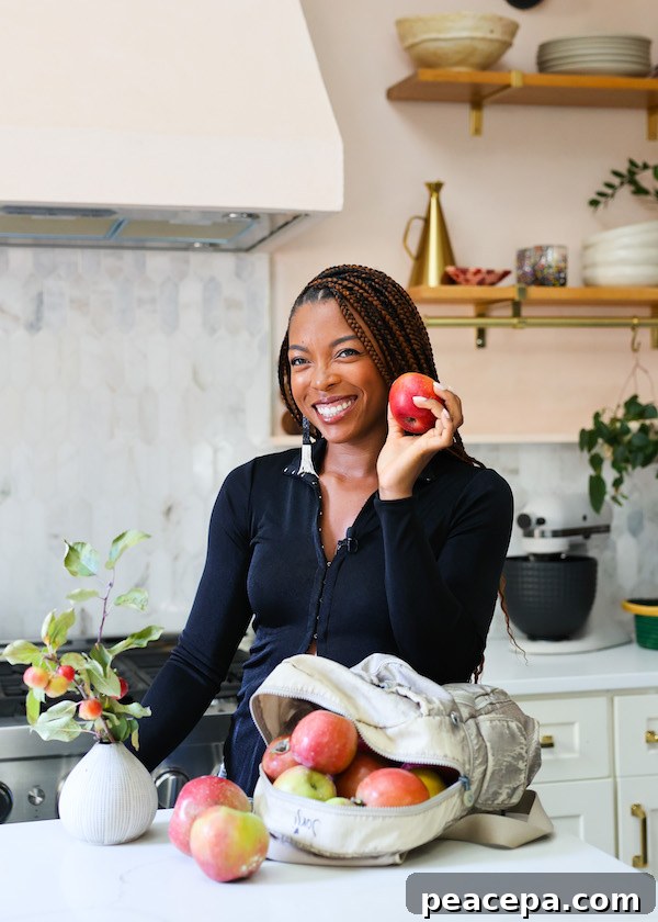 Jenne Claiborne in kitchen with apples