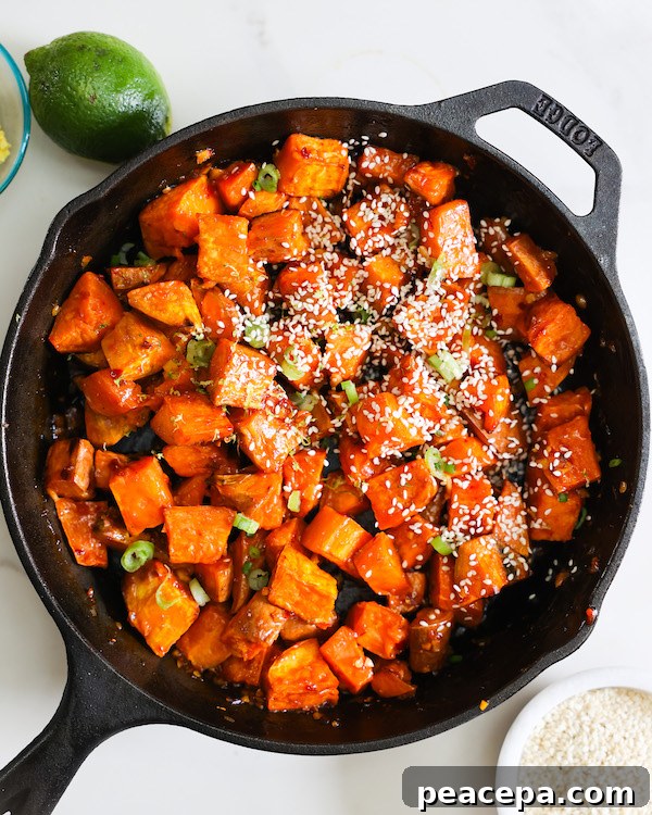 Chili lime glazed sweet potatoes served in a cast iron skillet.