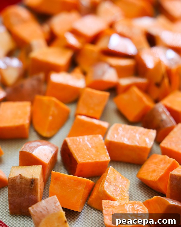 Raw sweet potatoes on a baking sheet