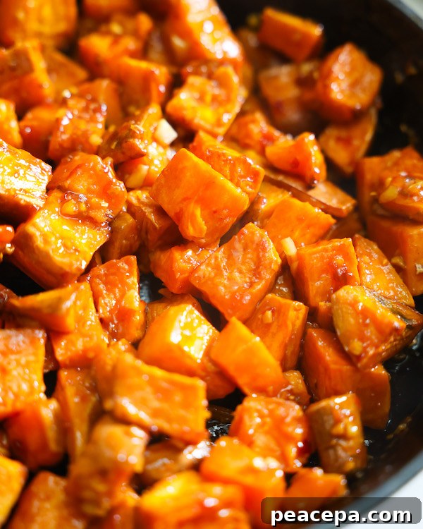 Glazed sweet potatoes in a black cast iron skillet