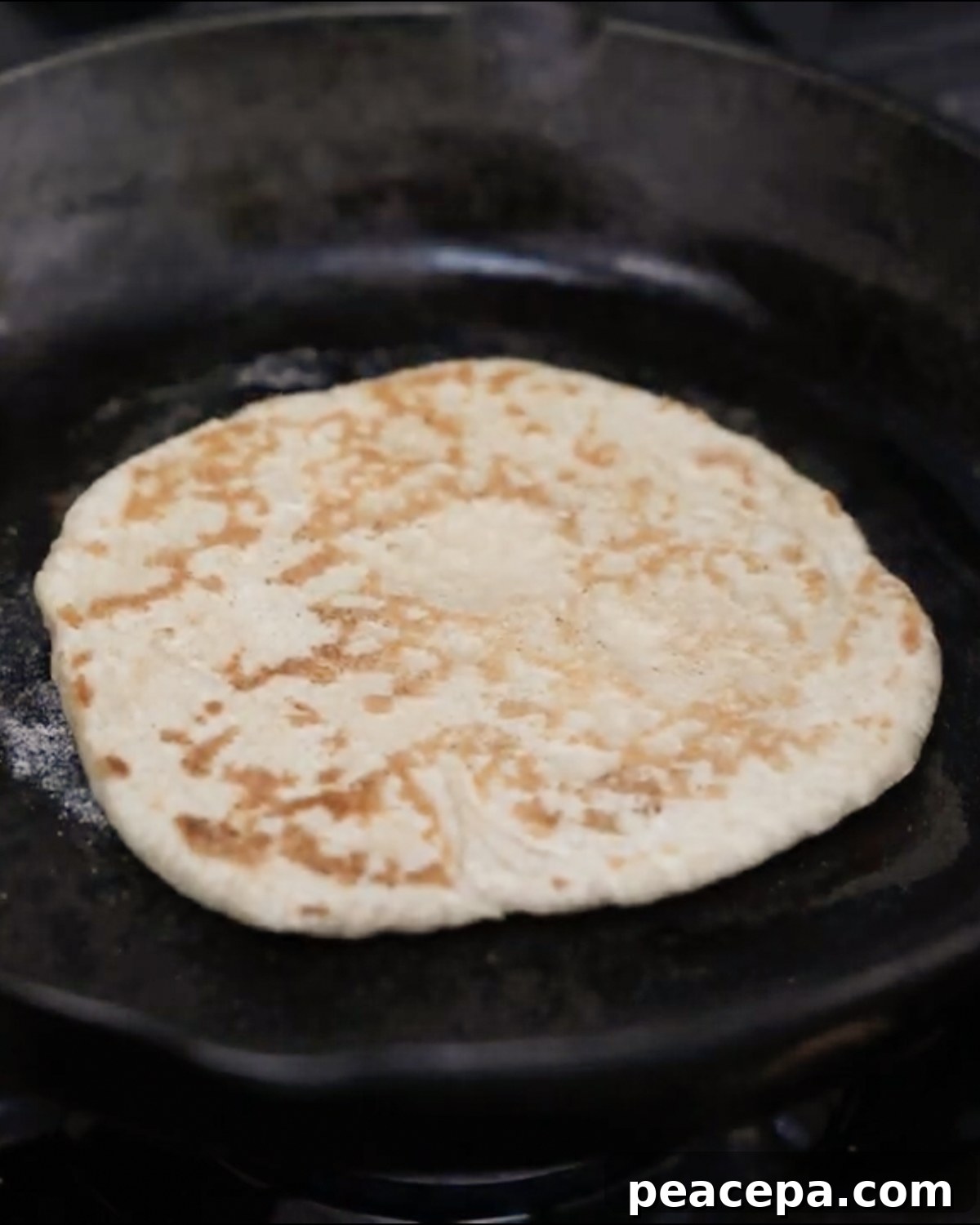 cooking naan on skillet