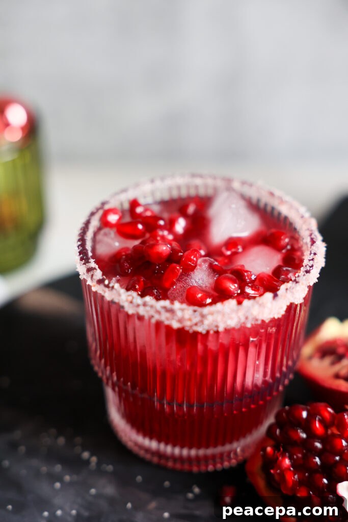pomegranate margarita topped with pomegranate arils
