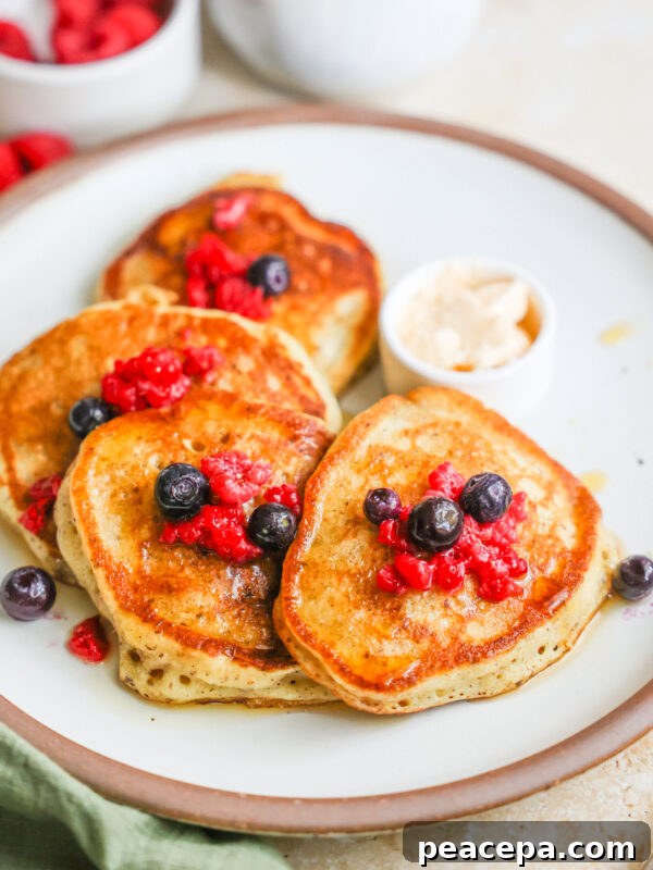 A plate of sourdough discard pancakes with berries.
