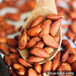 A close up of roasted tamari almonds on a baking sheet.