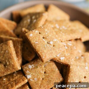 An up-close shot of "cheesy" pumpkin seed crackers in a bowl.