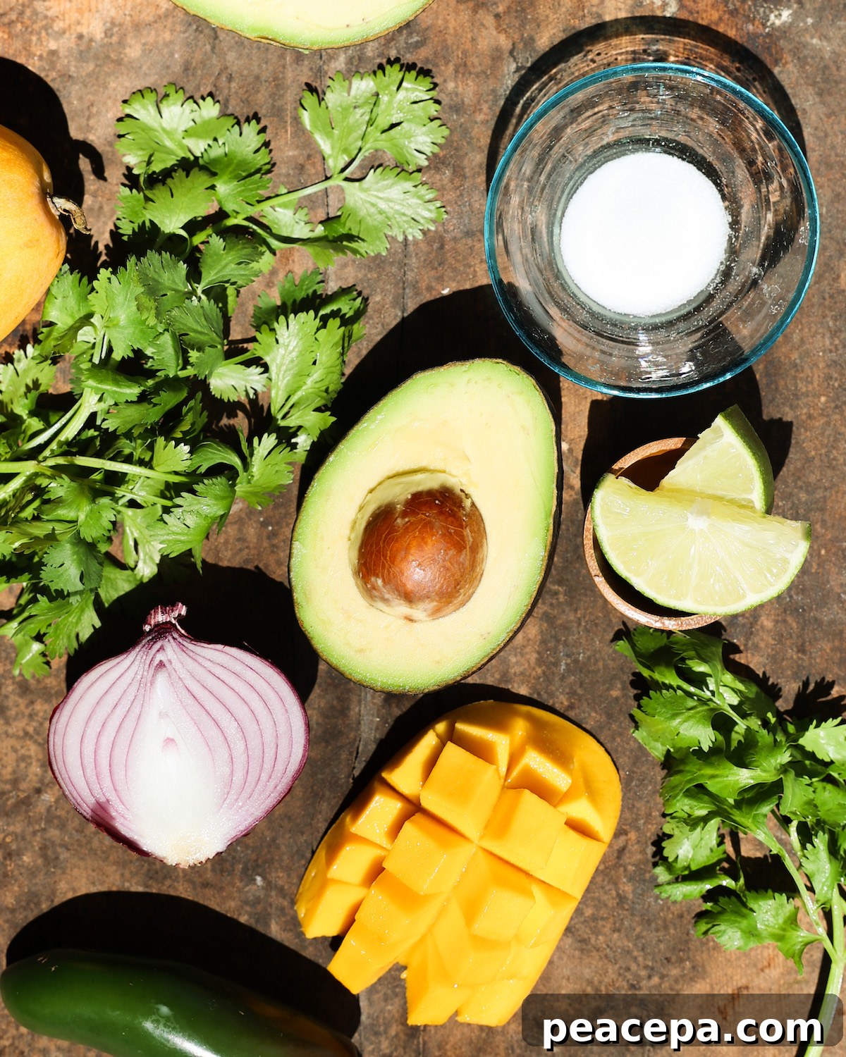 All of the ingredients for mango guacamole on the counter.