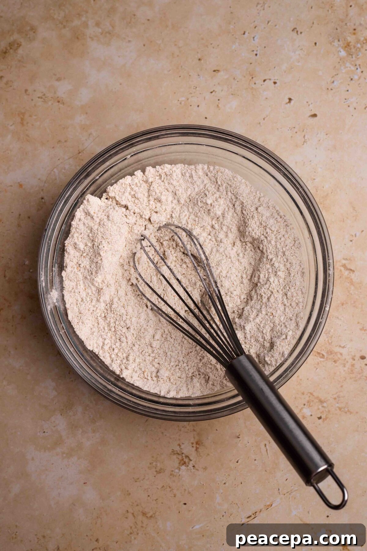 An overhead shot of a mixing bowl of the dry ingredients for the spelt pancakes.