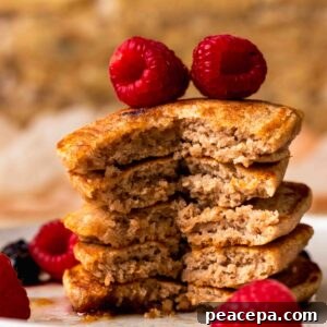 An up-close side shot of a small stack of the pancakes with a forkful taken out of it.