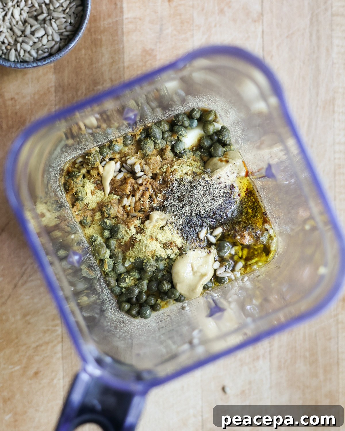 overhead of vegan caesar salad ingredients in a blender