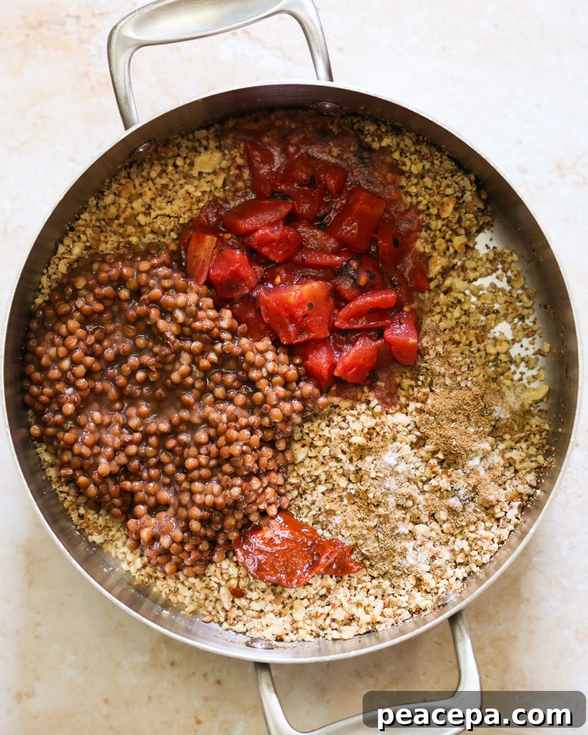 overhead of lentil taco meat ingredients added to pan