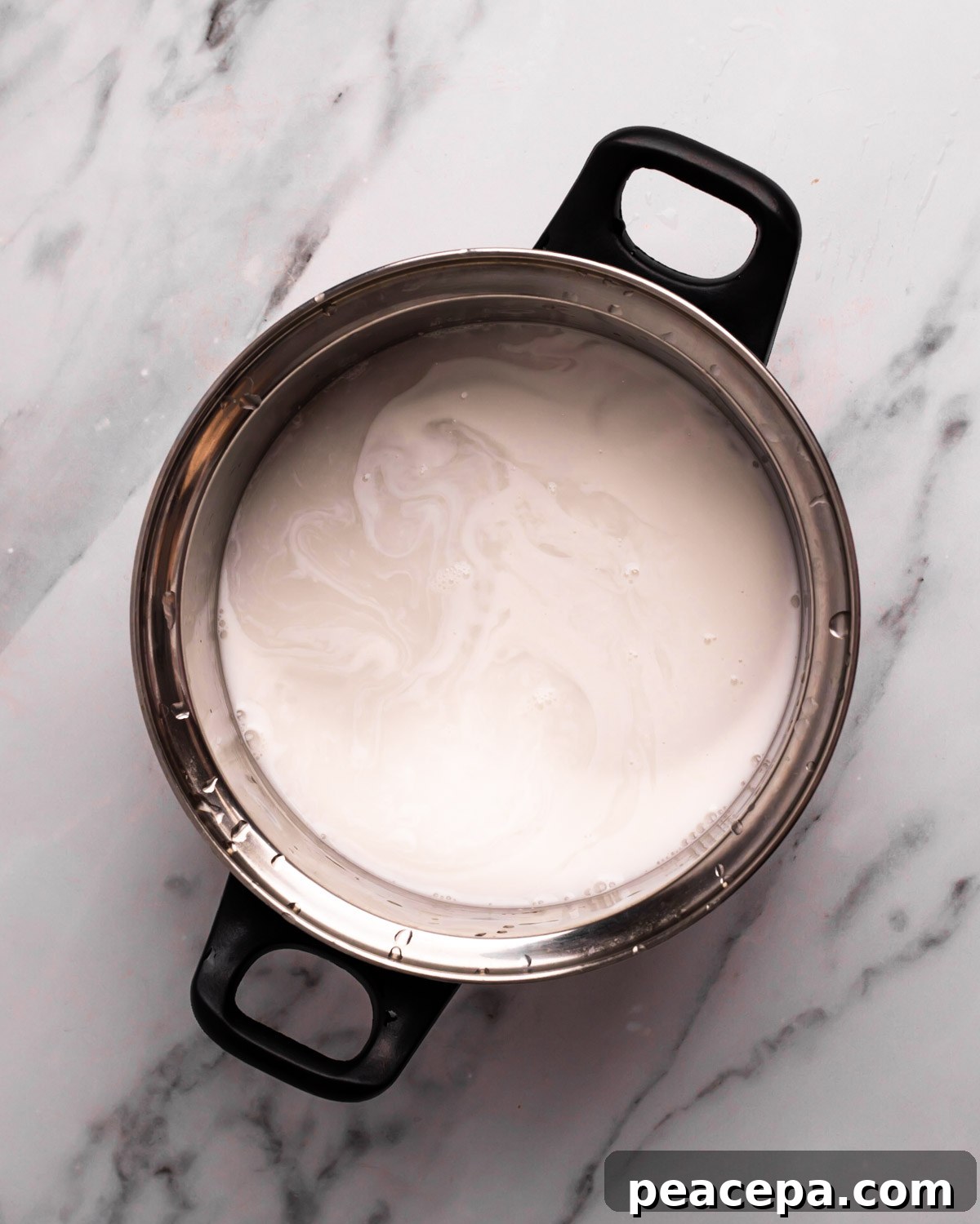 overhead of coconut milk in a pot