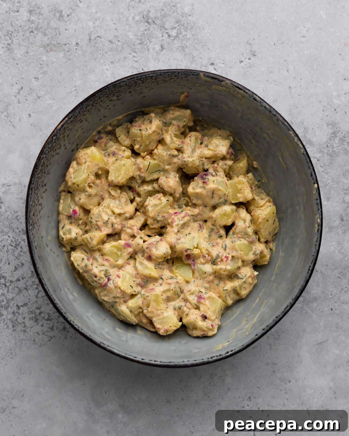 overhead of vegan potato salad mixed in bowl
