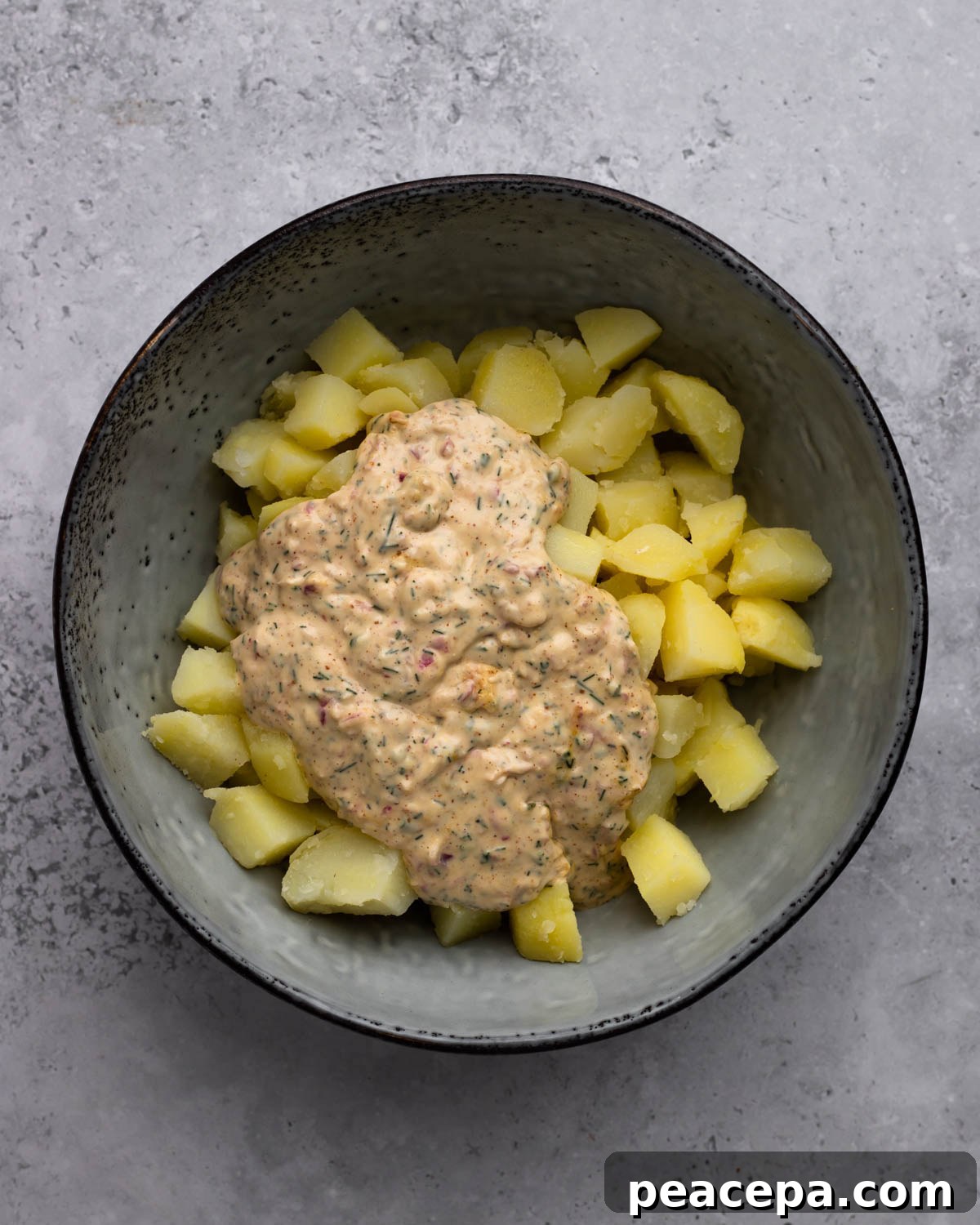 dressing poured over cubed potatoes