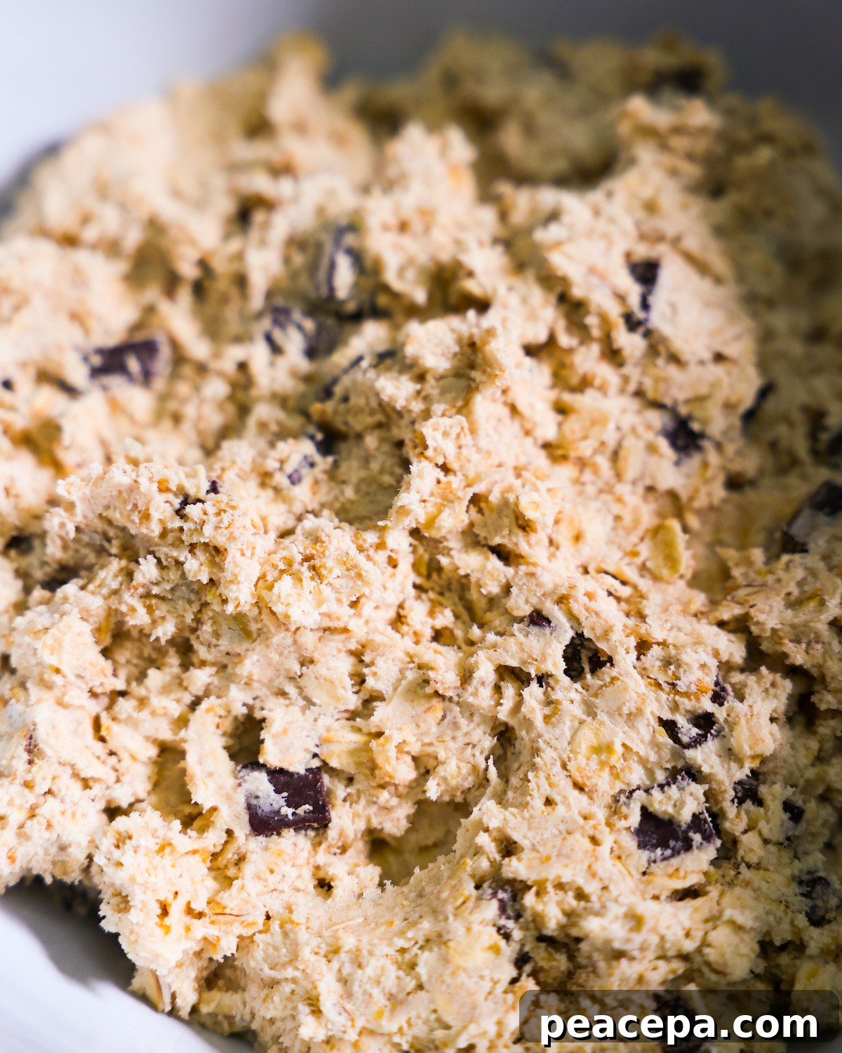closeup of vegan oatmeal chocolate chip cookie dough in bowl