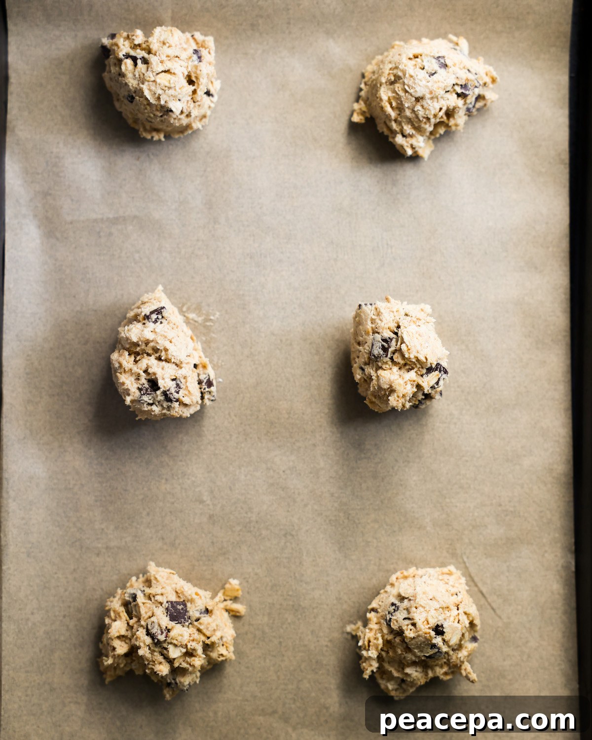overhead of vegan chocolate chip cookie dough balls on baking sheet