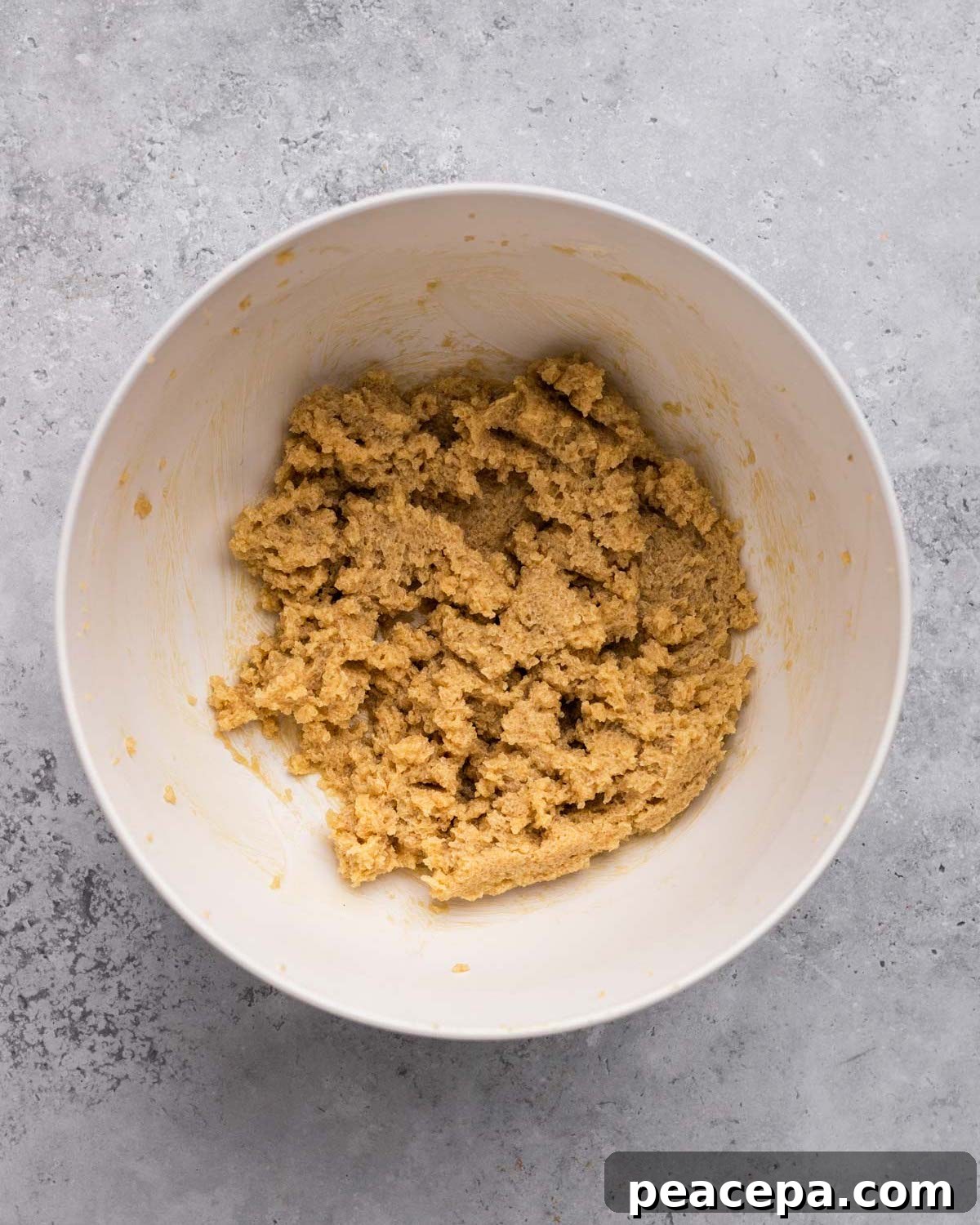 overhead of sugar and vegan butter creamed in bowl