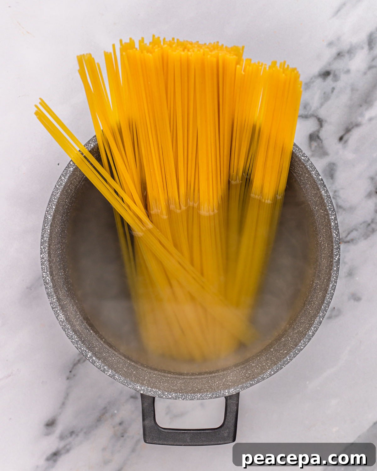 overhead of pasta cooking in pot