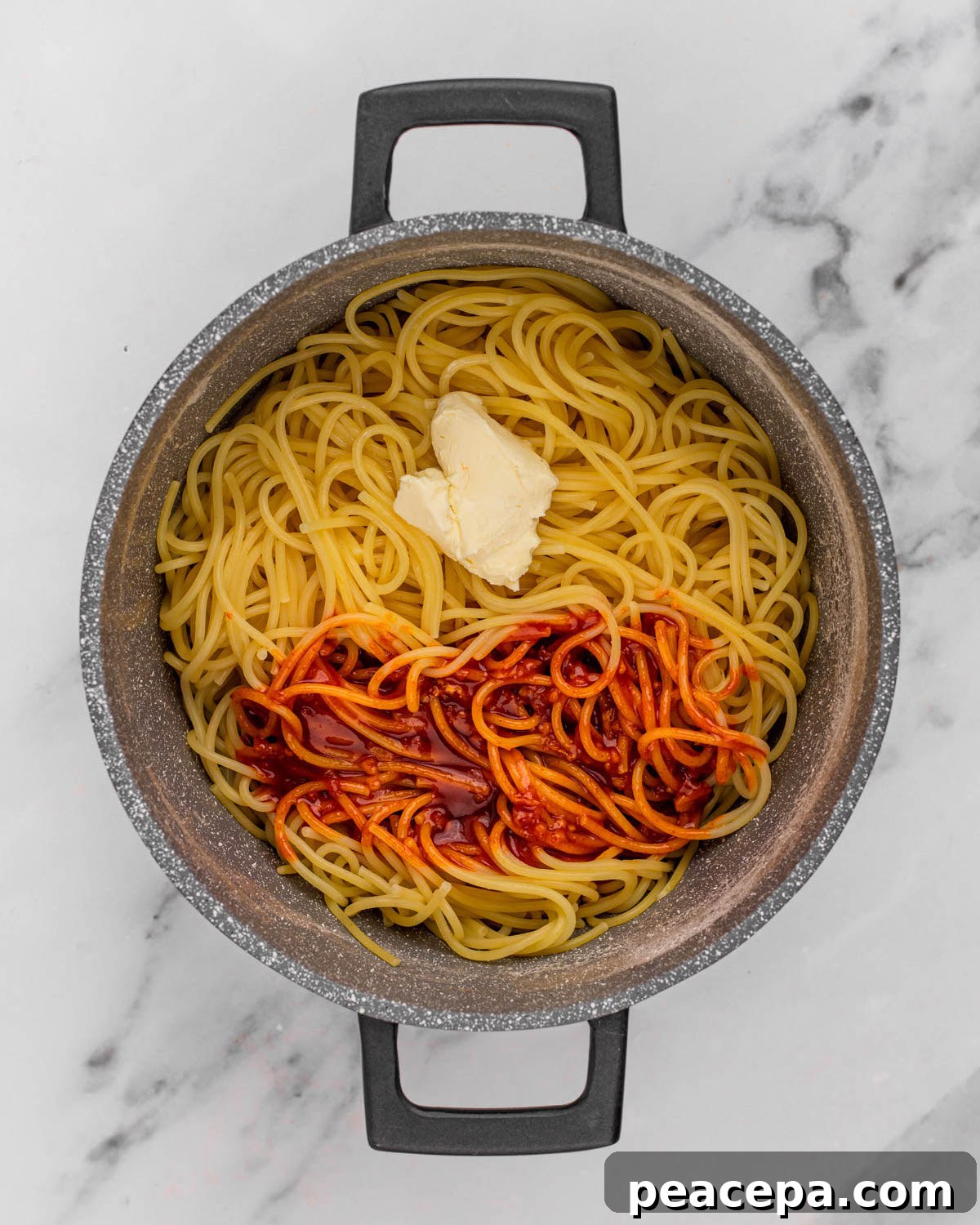 overhead of vegan butter and gochujang sauce on noodles