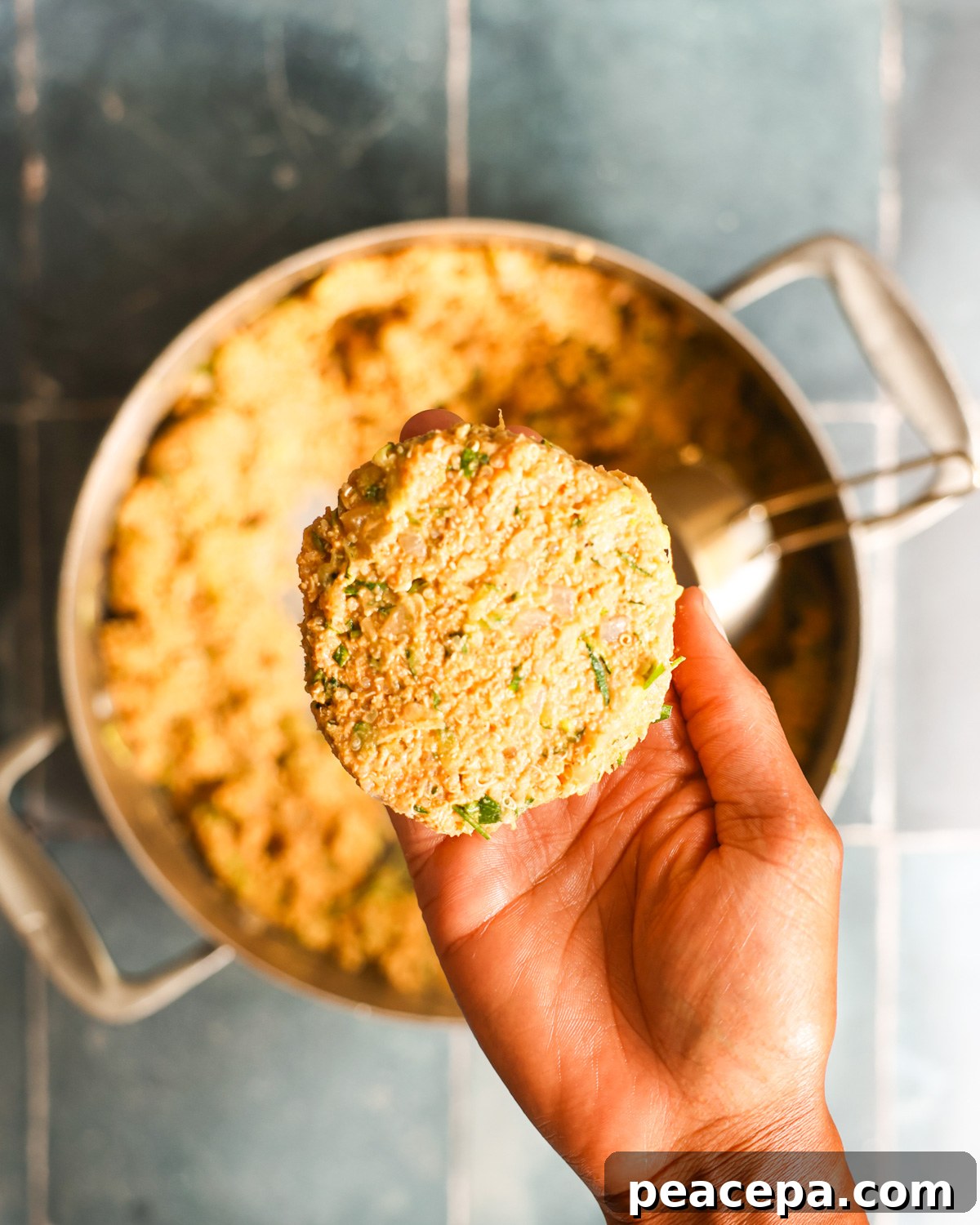 overhead of zucchini burger patty formed in hand