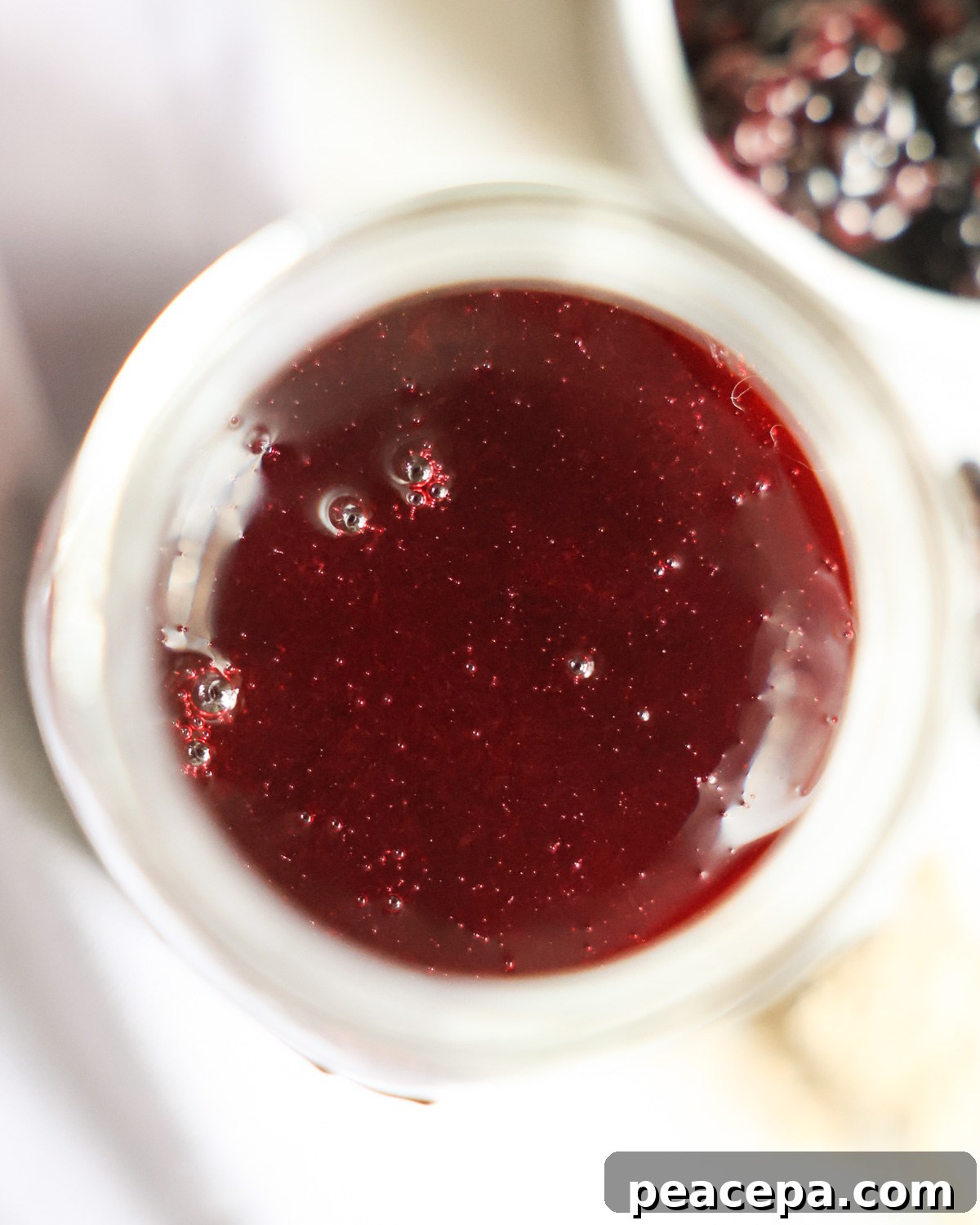 overhead of blackberry syrup in jar