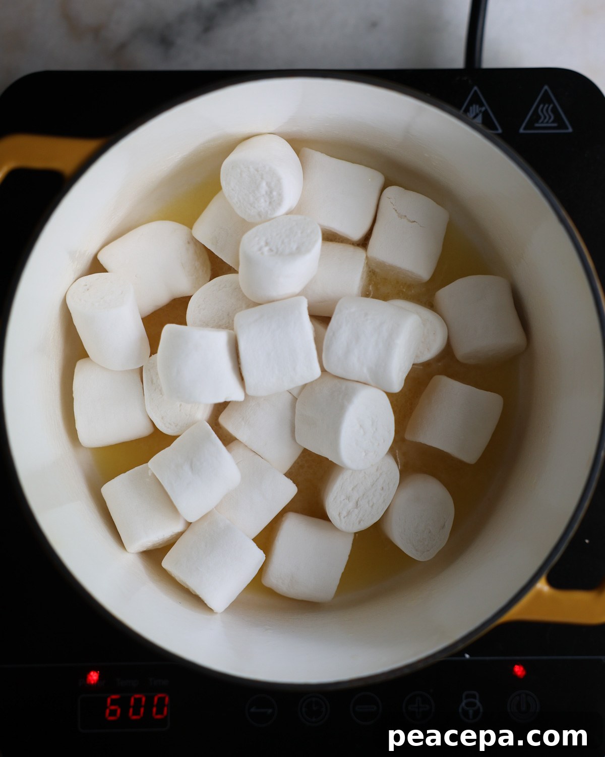 overhead of vegan marshmallows added to a pot