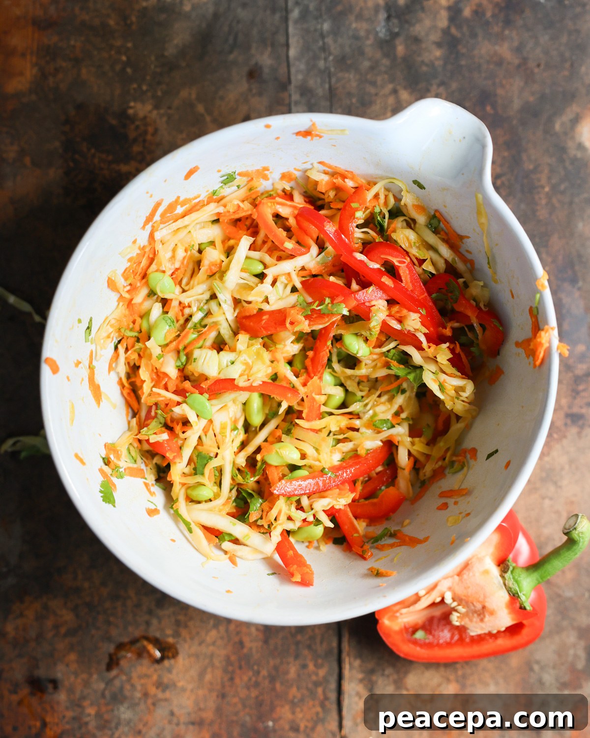 An overhead shot of a white mixing bowl of Crunchy Sesame Tofu Salad.