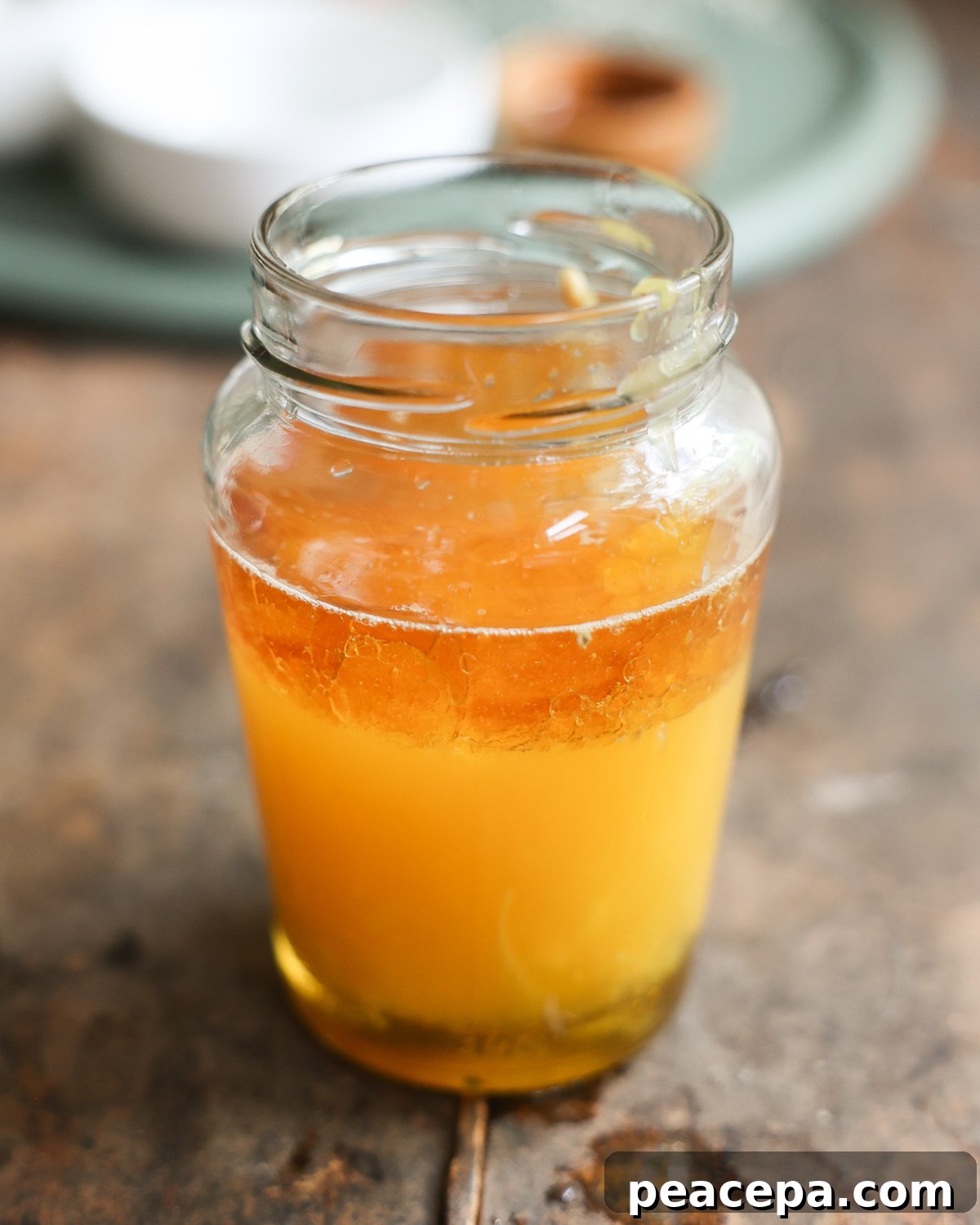 The ingredients for the orange sesame vinaigrette in a small glass jar.