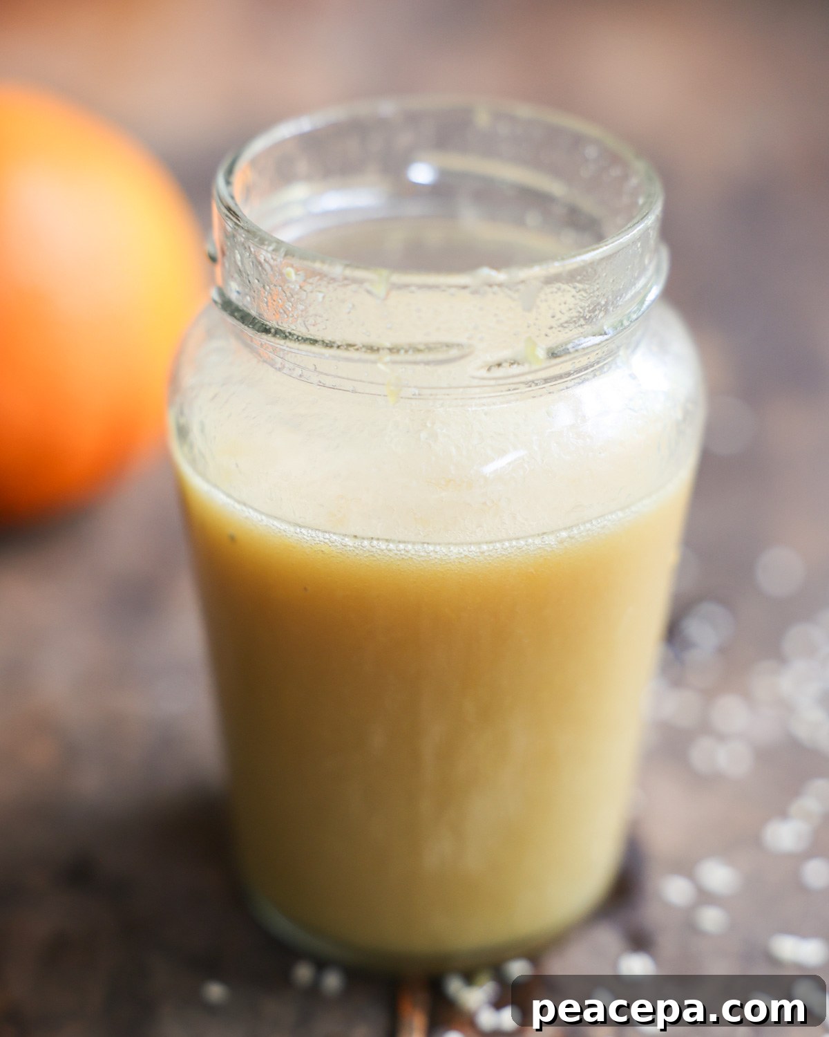 A small jar of the orange sesame vinaigrette on the counter.