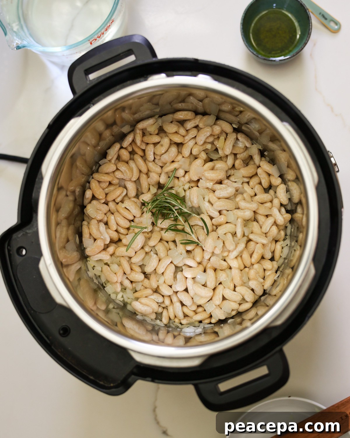 Beans and fresh rosemary in Instant Pot.
