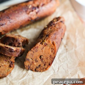 A close-up shot of cooked vegan sausage on crinkled parchment paper.
