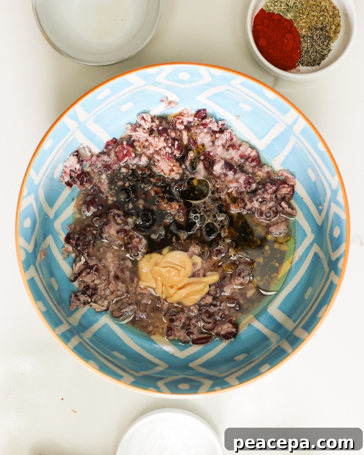 The mashed beans and wet ingredients in the mixing bowl.