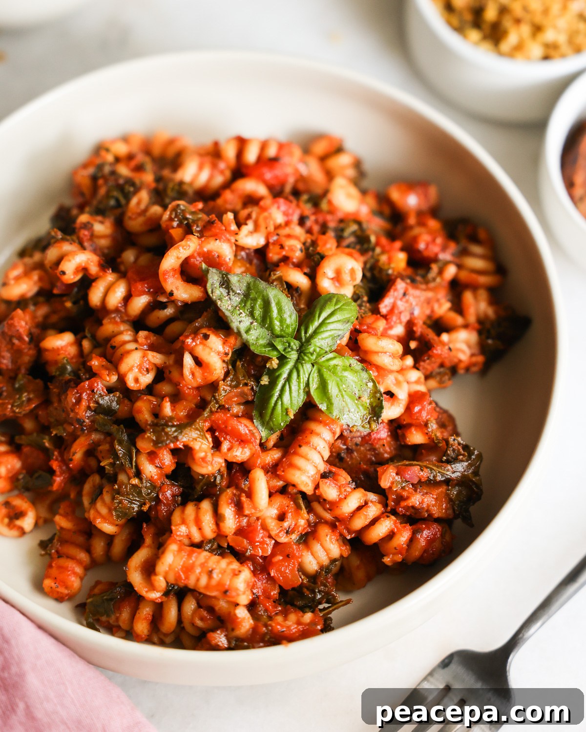 A closeup overhead shot of a bowl of Instant Pot Vegan Sausage Pasta.