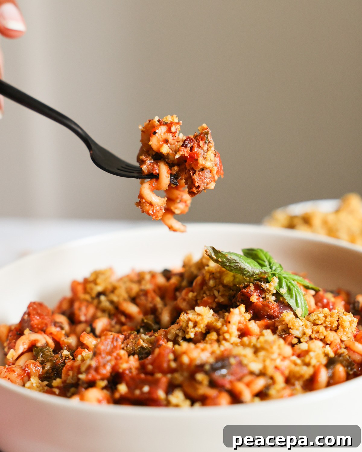 An up-close side shot of a bite of Instant Pot Vegan Sausage Pasta.