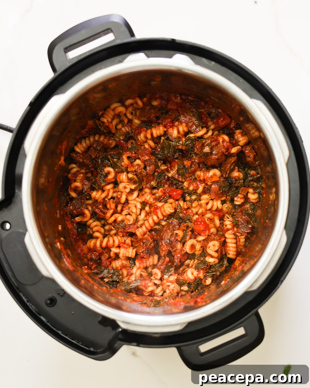 An Instant Pot full of the cooled vegan sausage pasta.