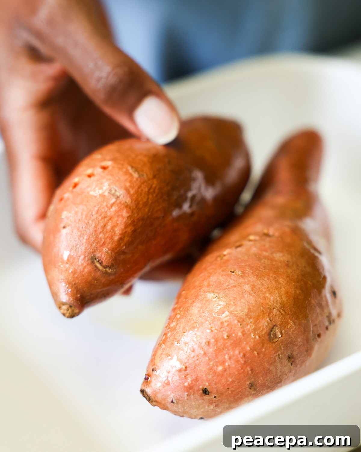 hand holding greased sweet potato