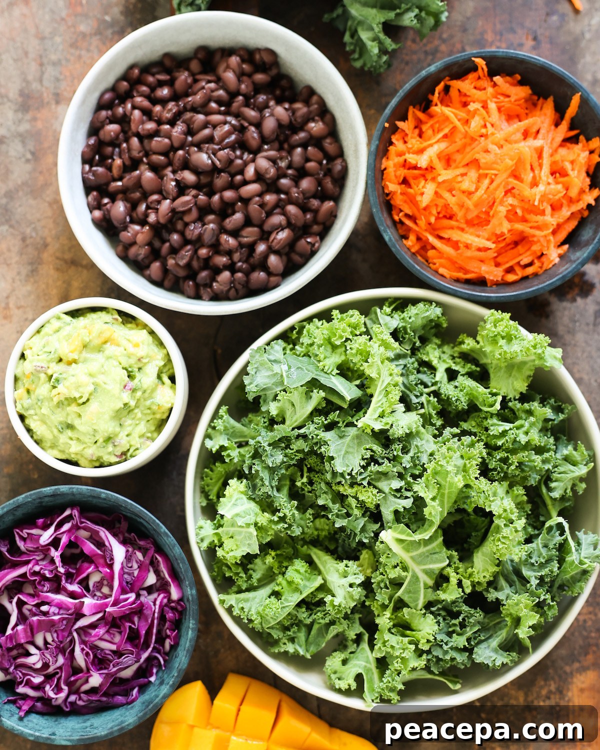 ingredients for mango avocado salad on a wooden background